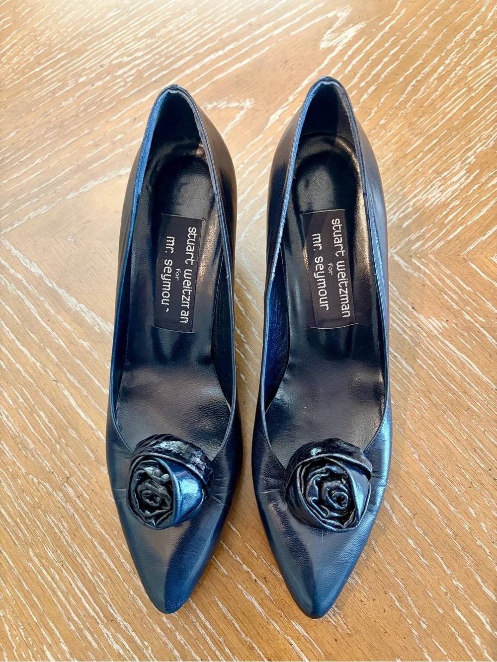 Stuart Weitzman Black Pointed Toe Pumps with Rosette
